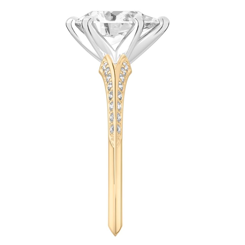 Side view of pear shape diamond split shank knife edge engagement ring in yellow gold
