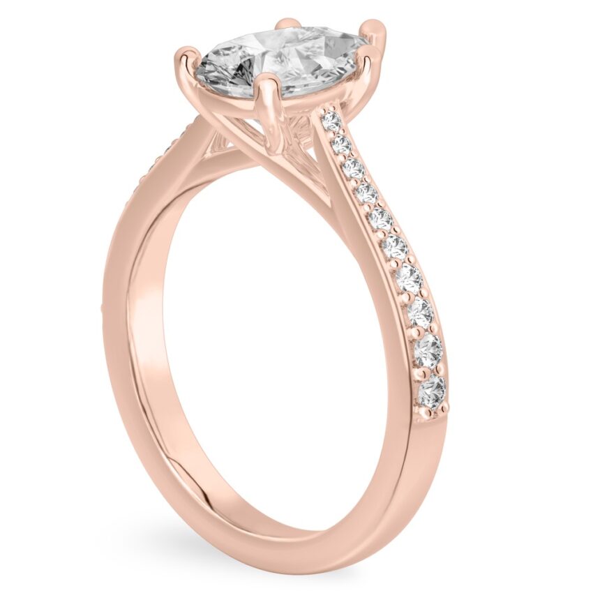 Angle view of pear shape diamond tapered engagement ring in rose gold