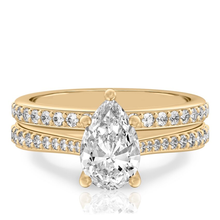 pear shape diamond tapered engagement ring set yellow gold