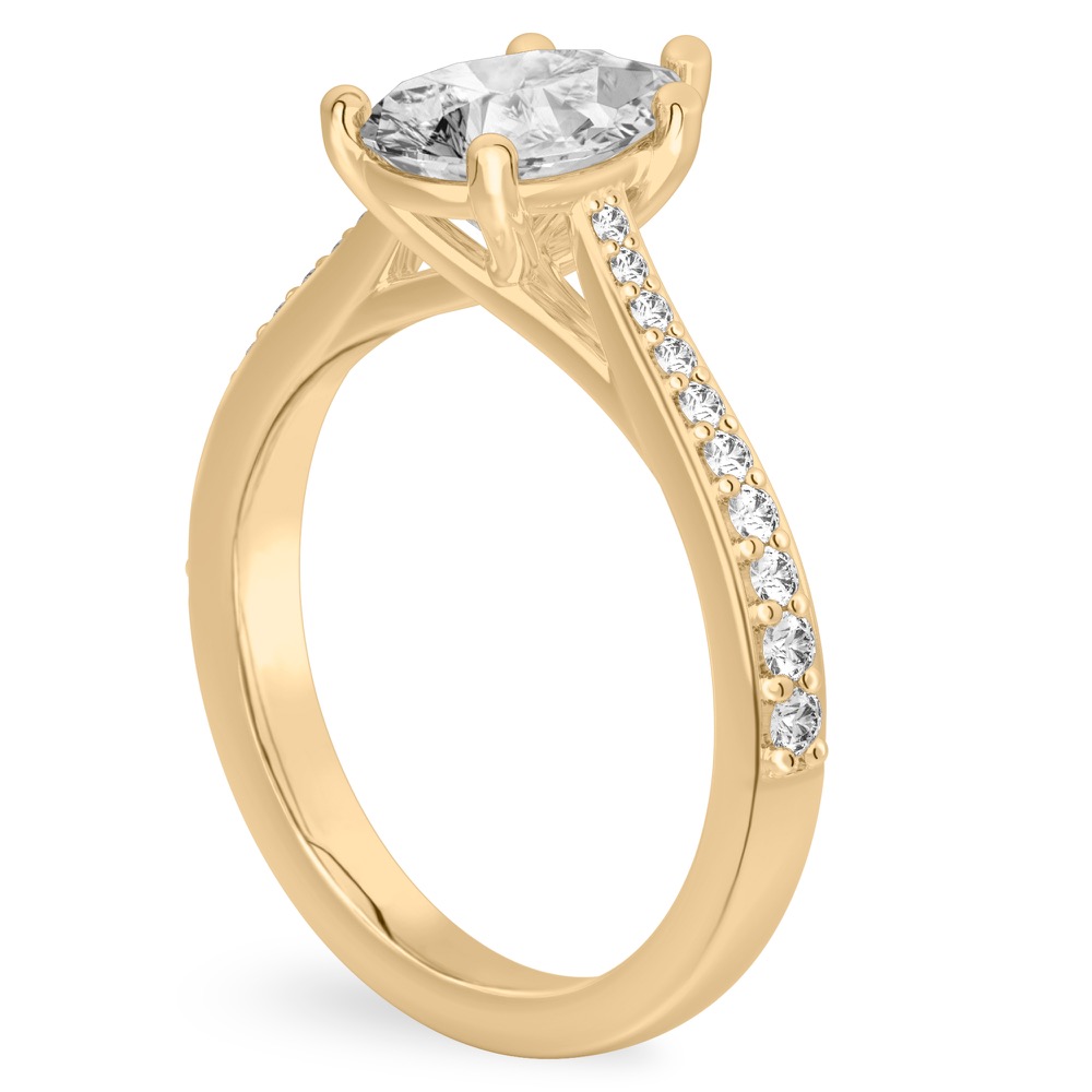 Angle view of pear shape diamond tapered engagement ring in yellow gold