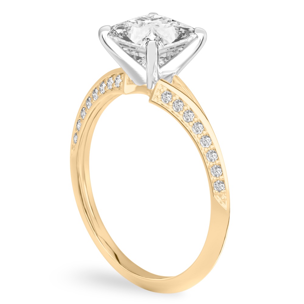 Angle view of princess cut diamond split shank knife edge engagement ring in yellow gold