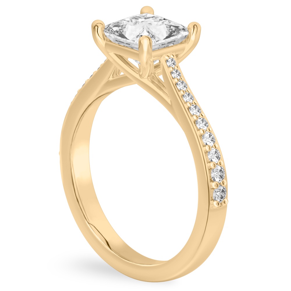 Angle view of princess cut diamond tapered engagement ring in yellow gold