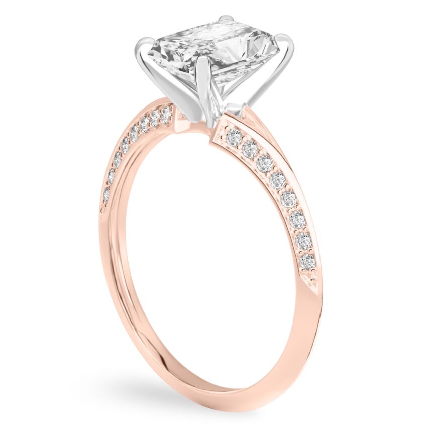 Angle view of radiant cut diamond split shank knife edge engagement ring in rose gold