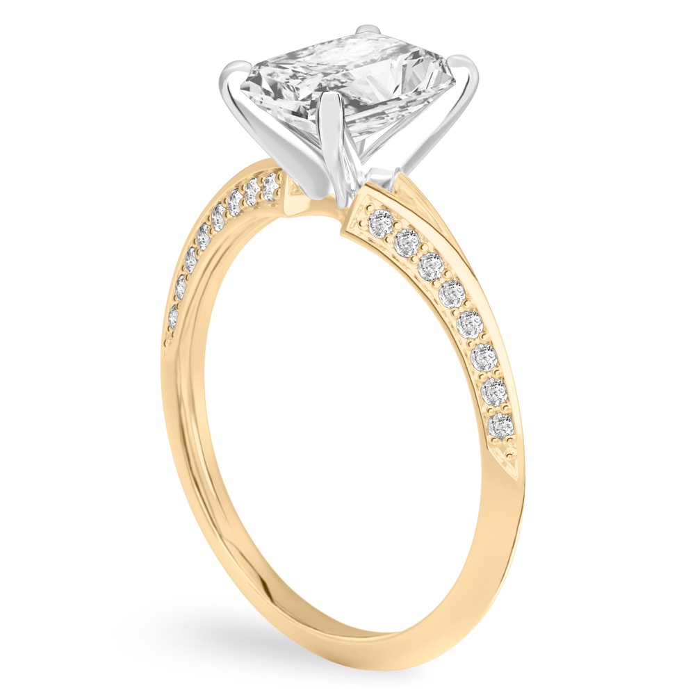 Angle view of radiant cut diamond split shank knife edge engagement ring in yellow gold