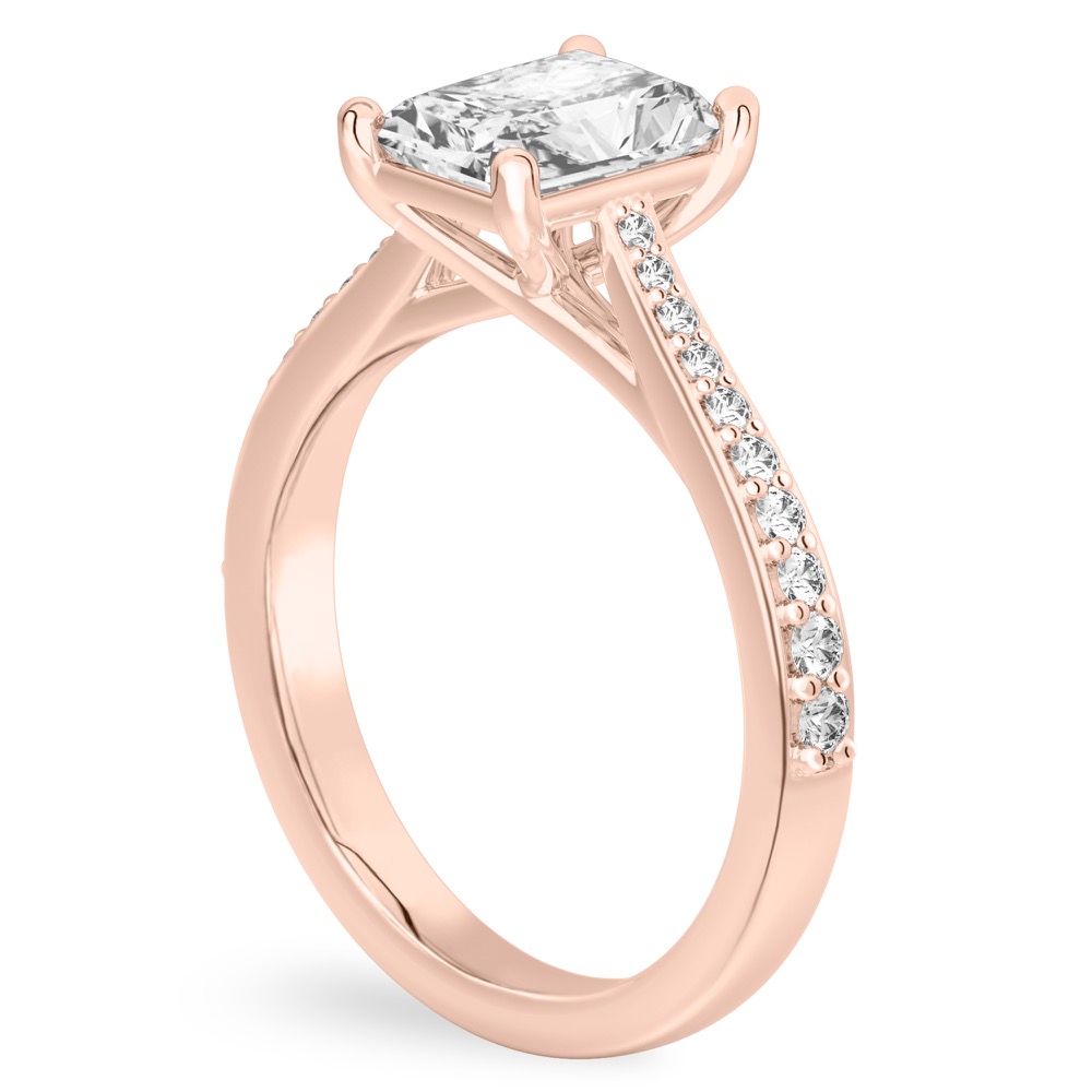 Angle view of radiant cut diamond tapered engagement ring in rose gold