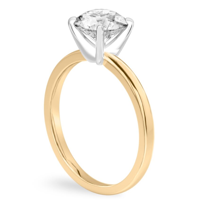 Angle view of round cut diamond classic solitaire engagement ring in yellow gold