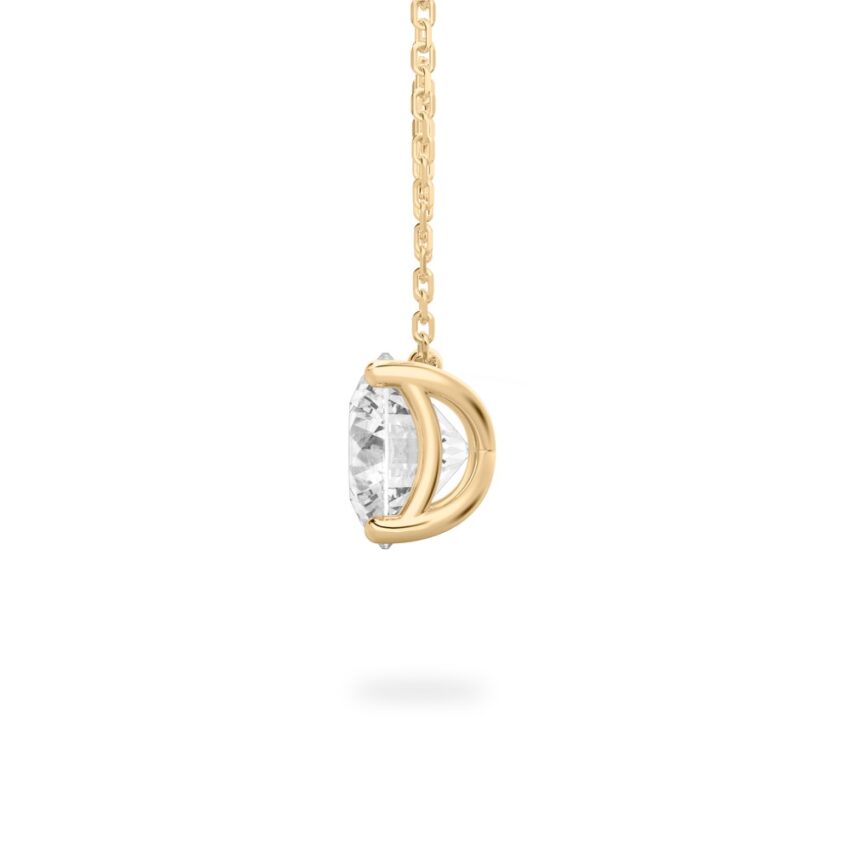 Side view of round cut diamond pendant necklace in yellow gold