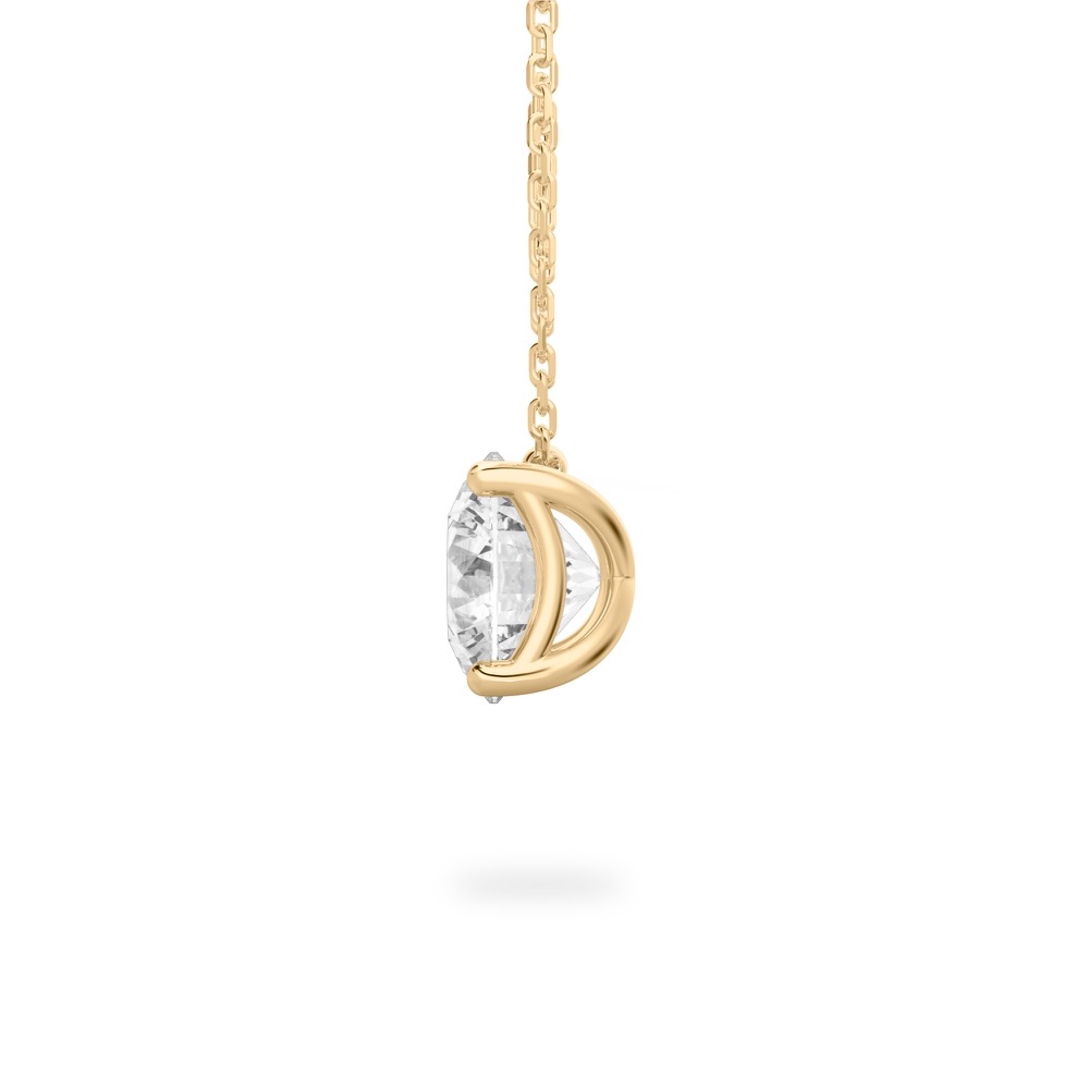Side view of round cut diamond pendant necklace in yellow gold