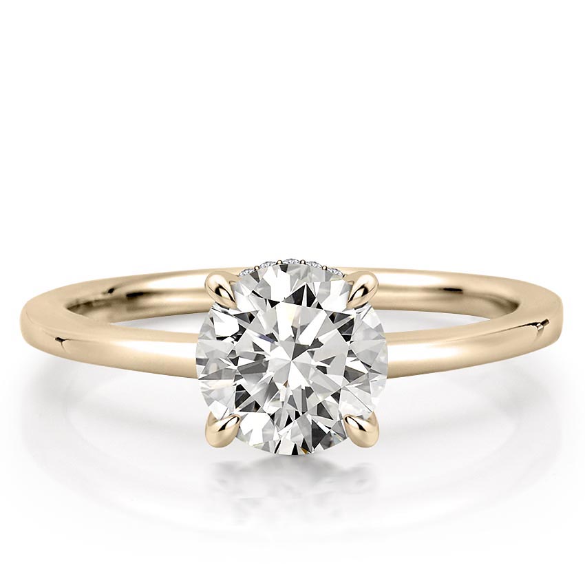 round cut diamond secret halo engagement ring in yellow gold