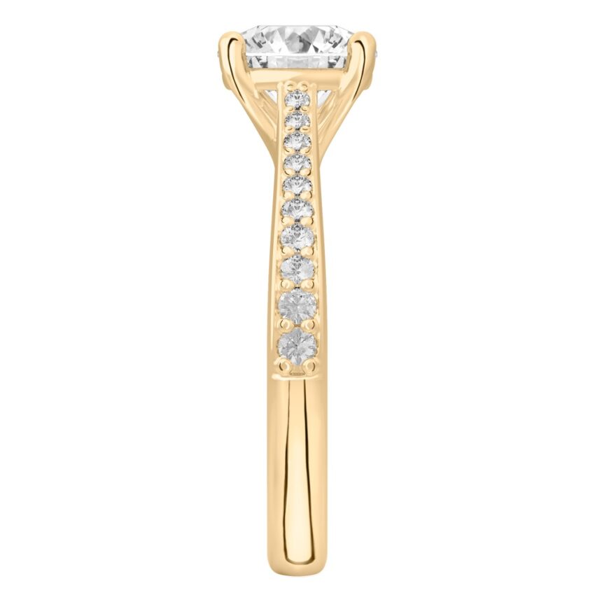 Side view of round cut diamond tapered engagement ring in yellow gold