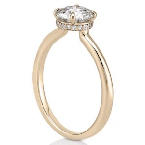 Angle view of secret halo engagement ring in yellow gold