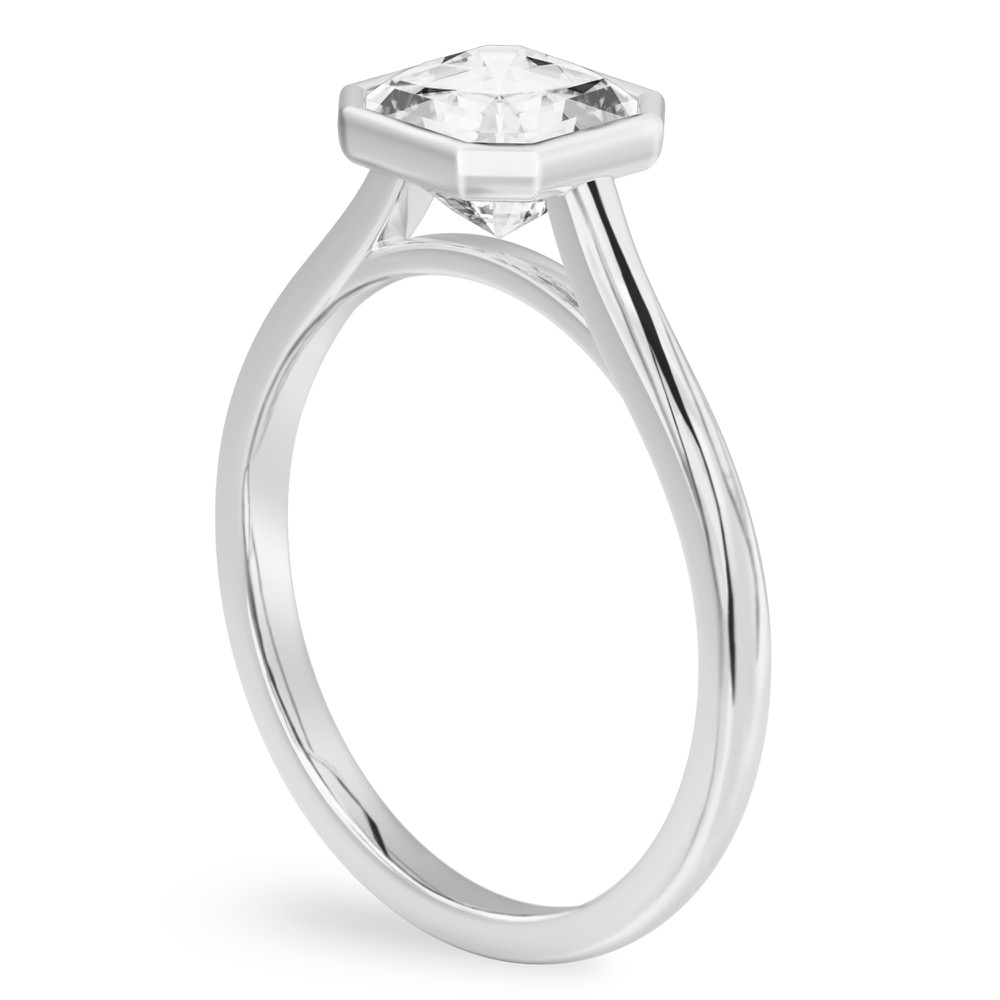 Angle view of asscher cut diamond bezel engagement ring in platinum