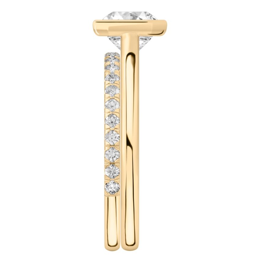 Side view of asscher cut diamond bezel engagement ring set yellow gold