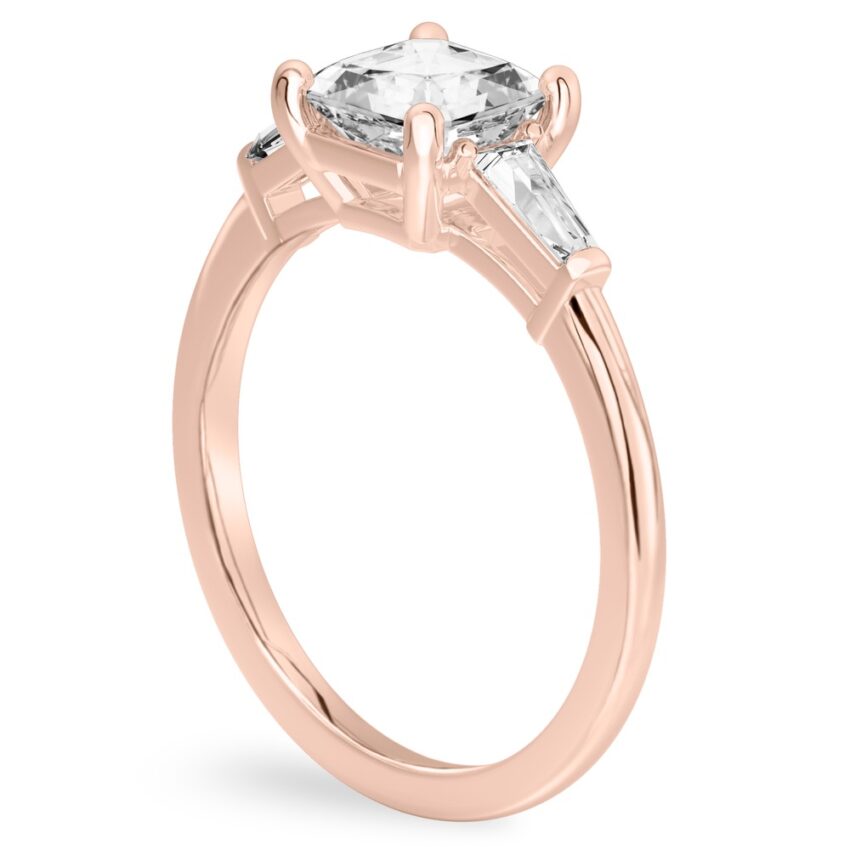 Angle view of asscher cut diamond tapered baguette engagement ring in rose gold