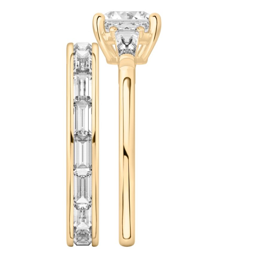 Side view of asscher cut diamond tapered baguette engagement ring set yellow gold