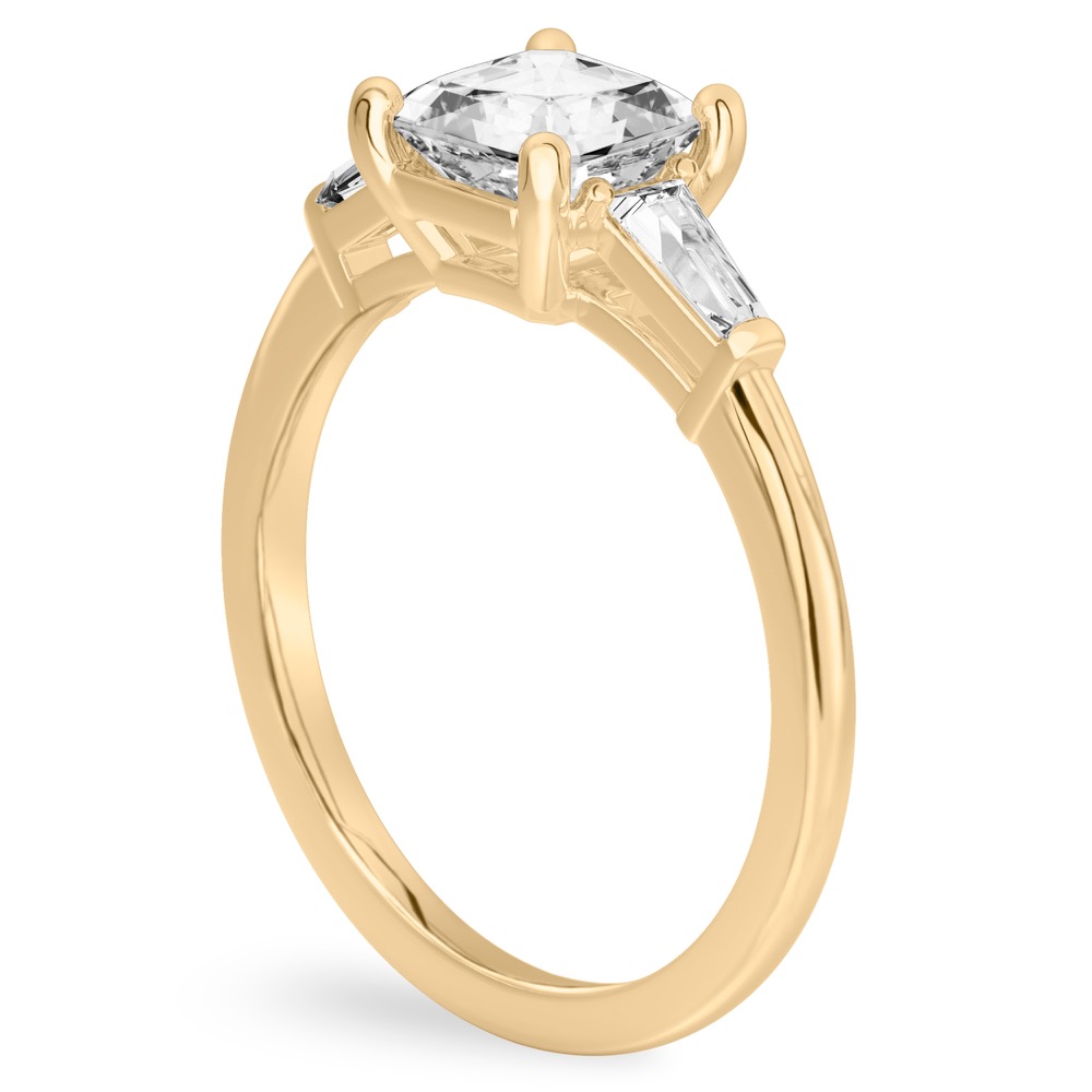 Angle view of asscher cut diamond tapered baguette engagement ring in yellow gold
