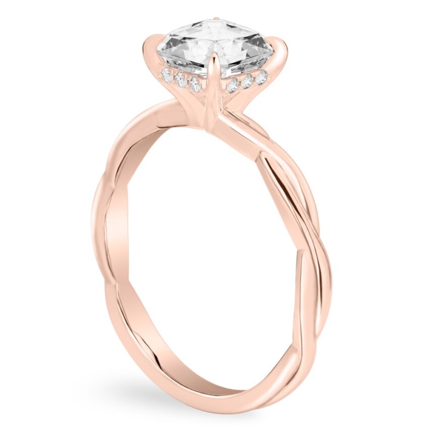 Angle view of asscher cut diamond twisted hidden halo engagement ring in rose gold