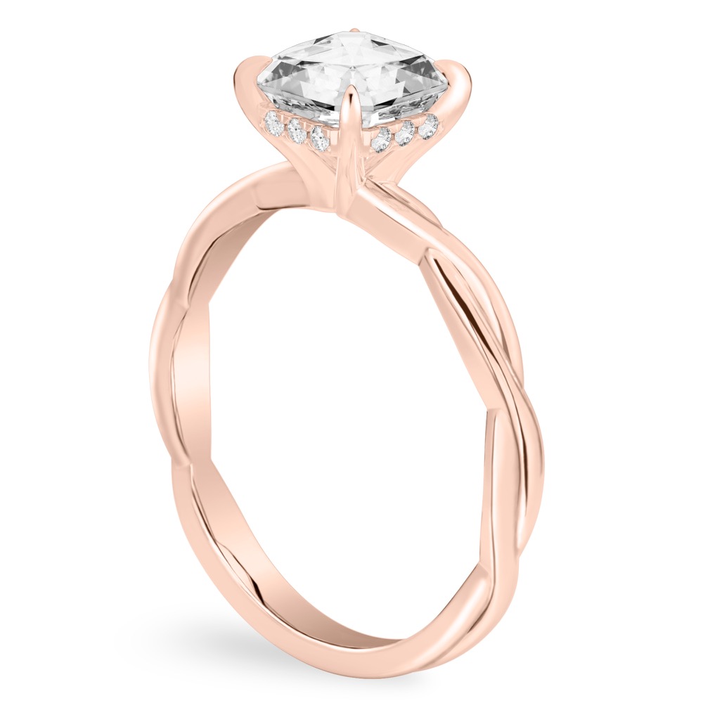 Angle view of asscher cut diamond twisted hidden halo engagement ring in rose gold