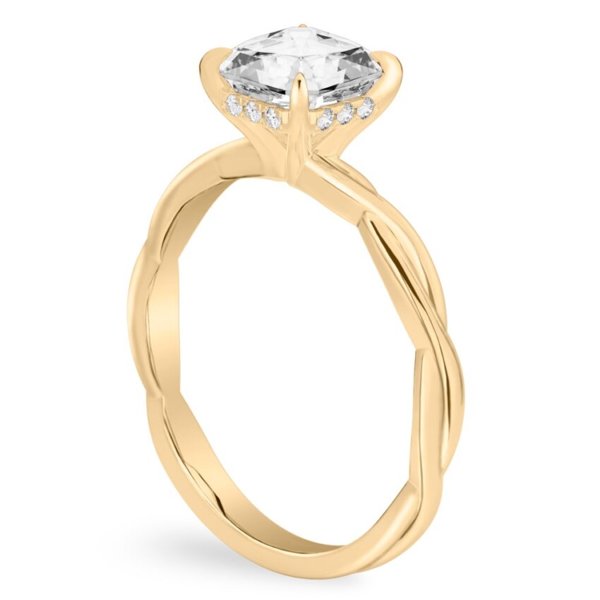Angle view of asscher cut diamond twisted hidden halo engagement ring in yellow gold