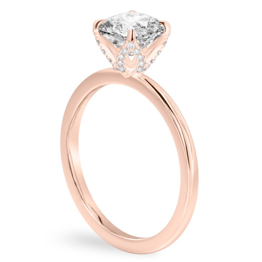 Angle view of cushion cut diamond pave petal prong engagement ring in rose gold