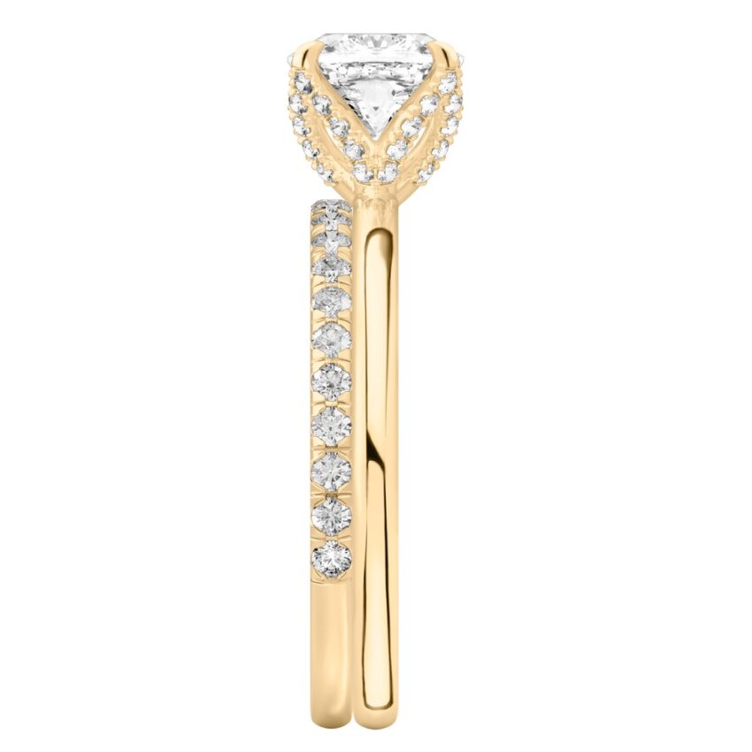 Side view of cushion cut diamond pave petal prong engagement ring set yellow gold