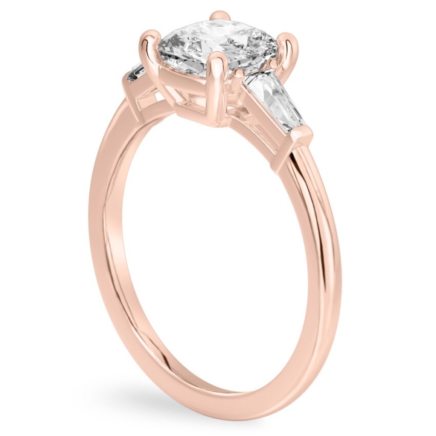 Angle view of cushion cut diamond tapered baguette engagement ring in rose gold