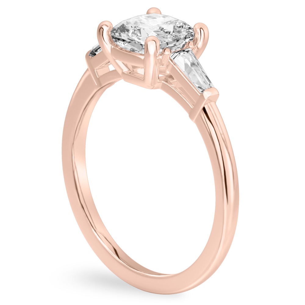 Angle view of cushion cut diamond tapered baguette engagement ring in rose gold