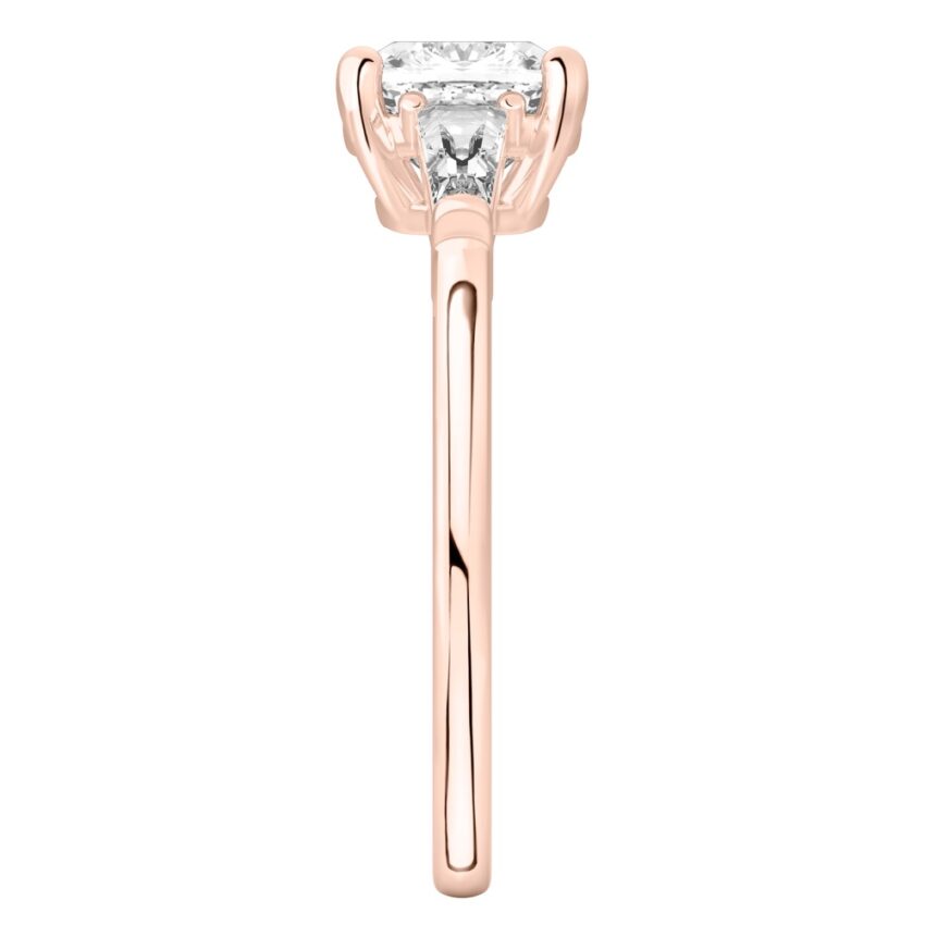 Side view of cushion cut diamond tapered baguette engagement ring in rose gold