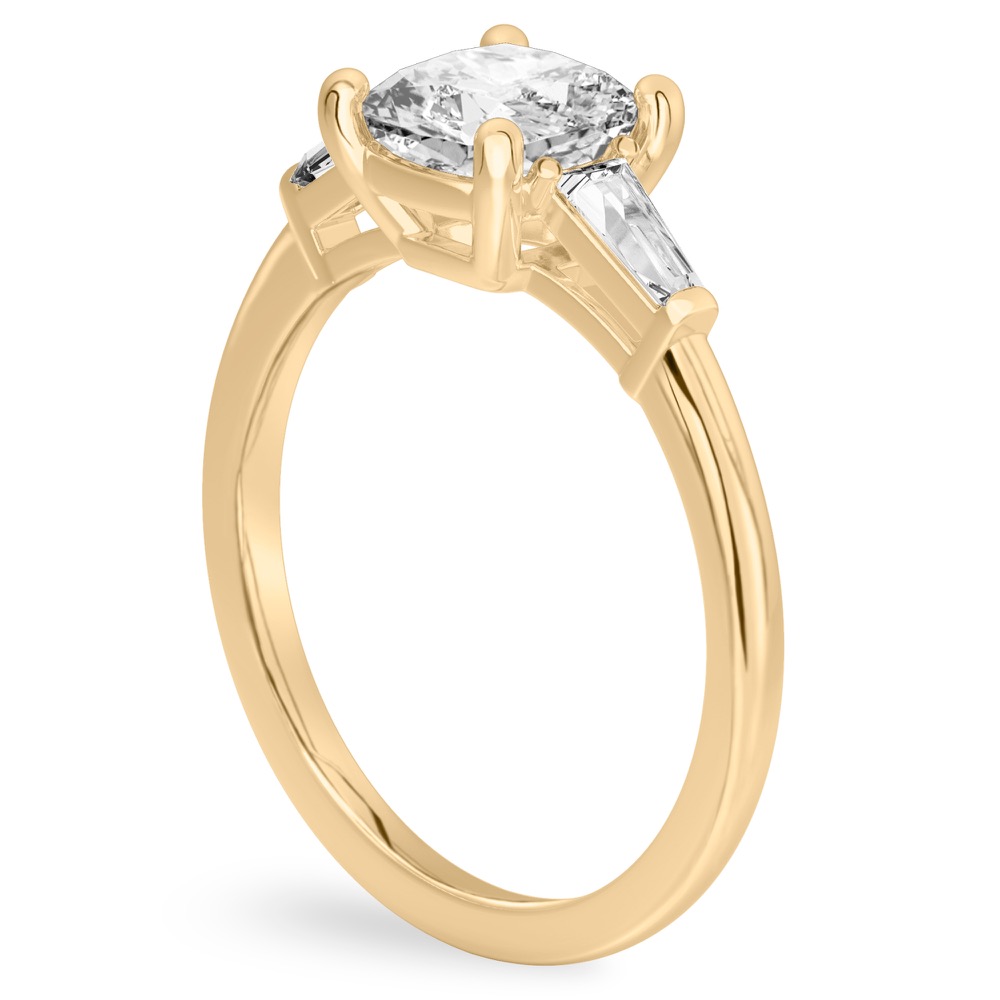 Angle view of cushion cut diamond tapered baguette engagement ring in yellow gold