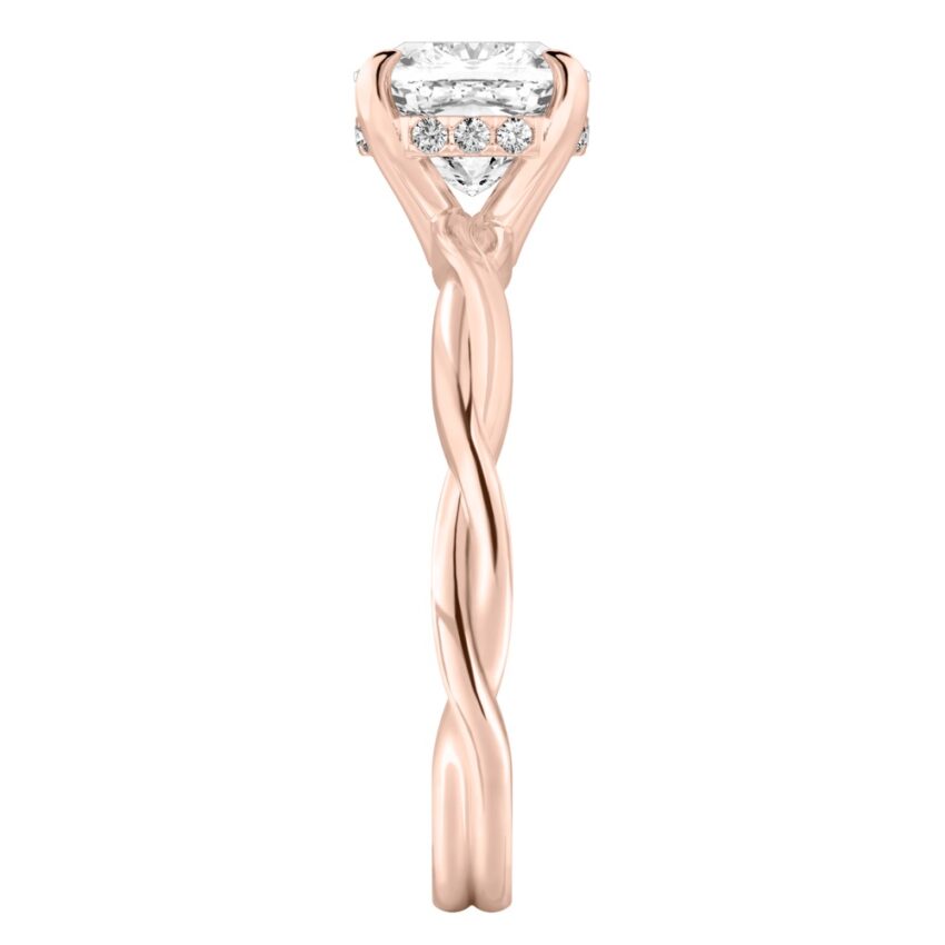 Side view of cushion cut diamond twisted hidden halo engagement ring in rose gold
