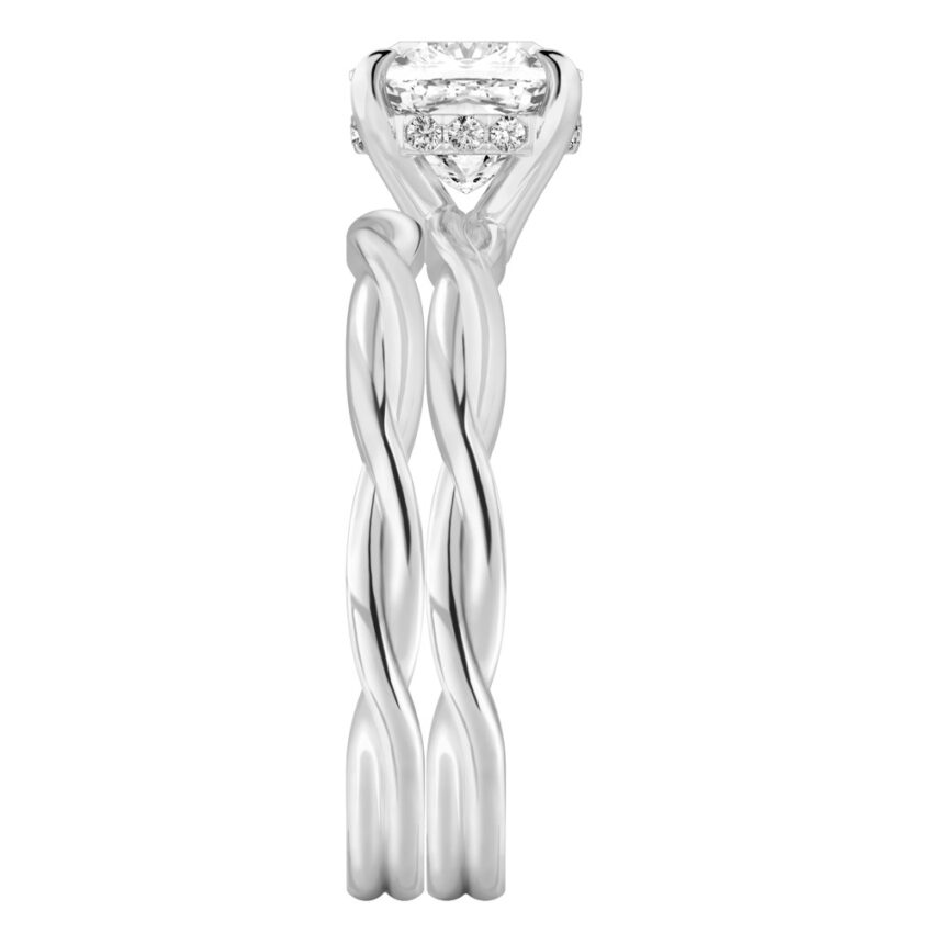 Side view of cushion cut diamond twisted hidden halo engagement ring set palladium
