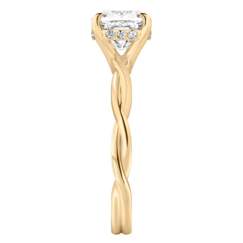Side view of cushion cut diamond twisted hidden halo engagement ring in yellow gold