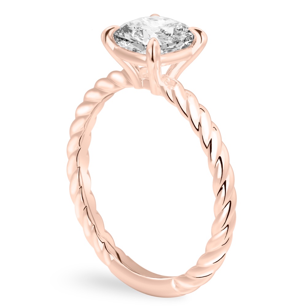 Angle view of cushion cut diamond twisted rope engagement ring in rose gold