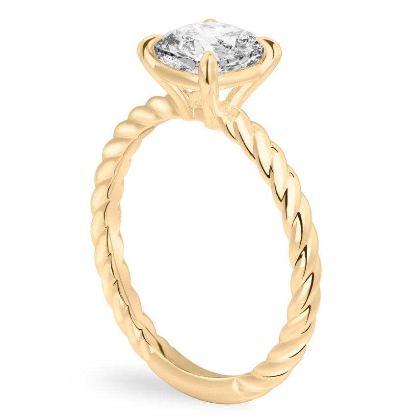 Angle view of cushion cut diamond twisted rope engagement ring in yellow gold