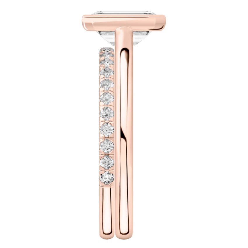 Side view of emerald cut diamond bezel engagement ring set rose gold
