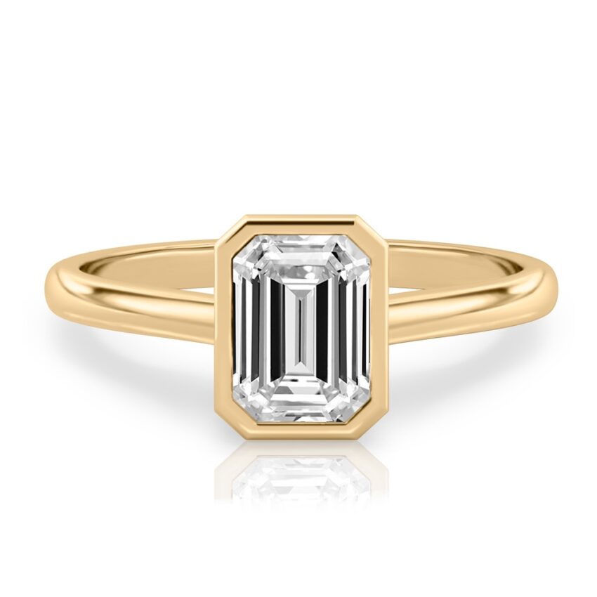 emerald cut diamond bezel engagement ring in yellow gold