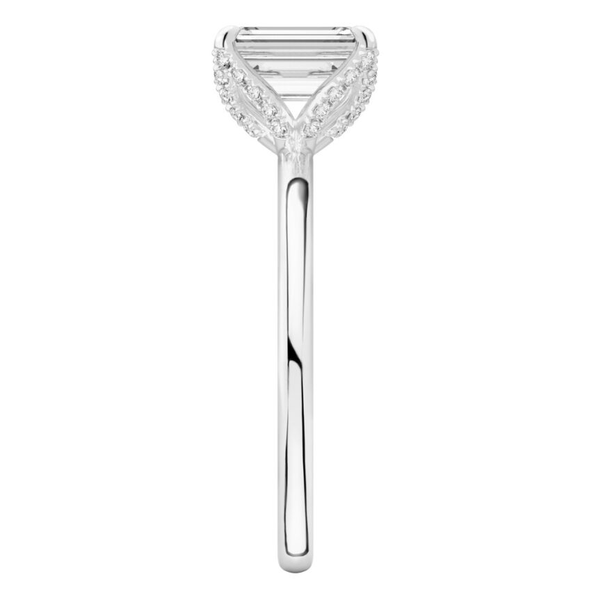 Side view of emerald cut diamond pave petal prong engagement ring in platinum