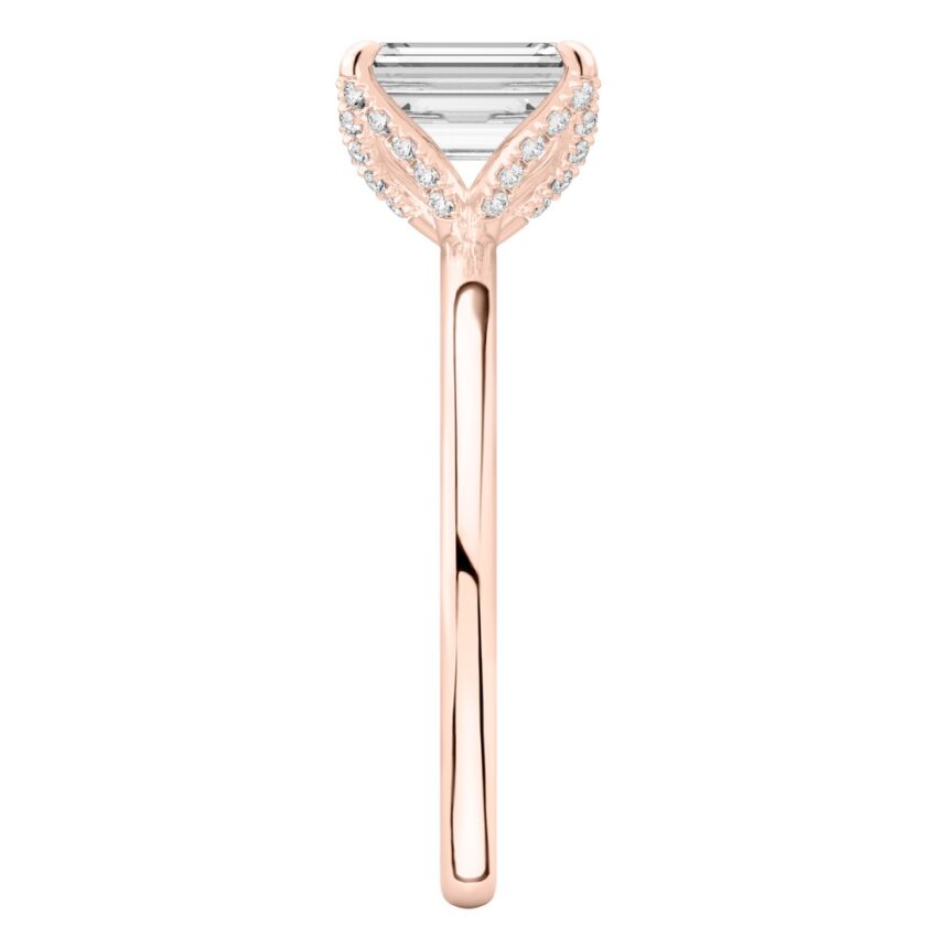 Side view of emerald cut diamond pave petal prong engagement ring in rose gold