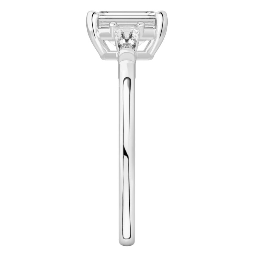 Side view of emerald cut diamond tapered baguette engagement ring in palladium