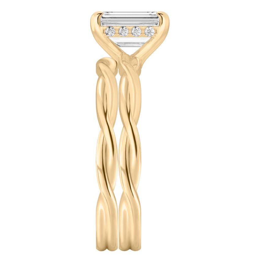 Side view of emerald cut diamond twisted hidden halo engagement ring set yellow gold