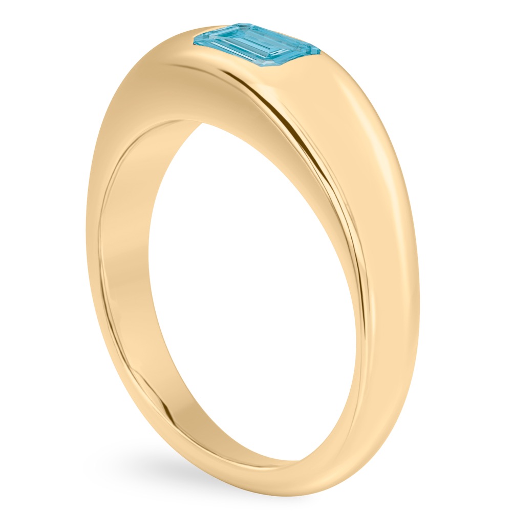 Angle view of emerald cut march birthstone dome ring yellow gold