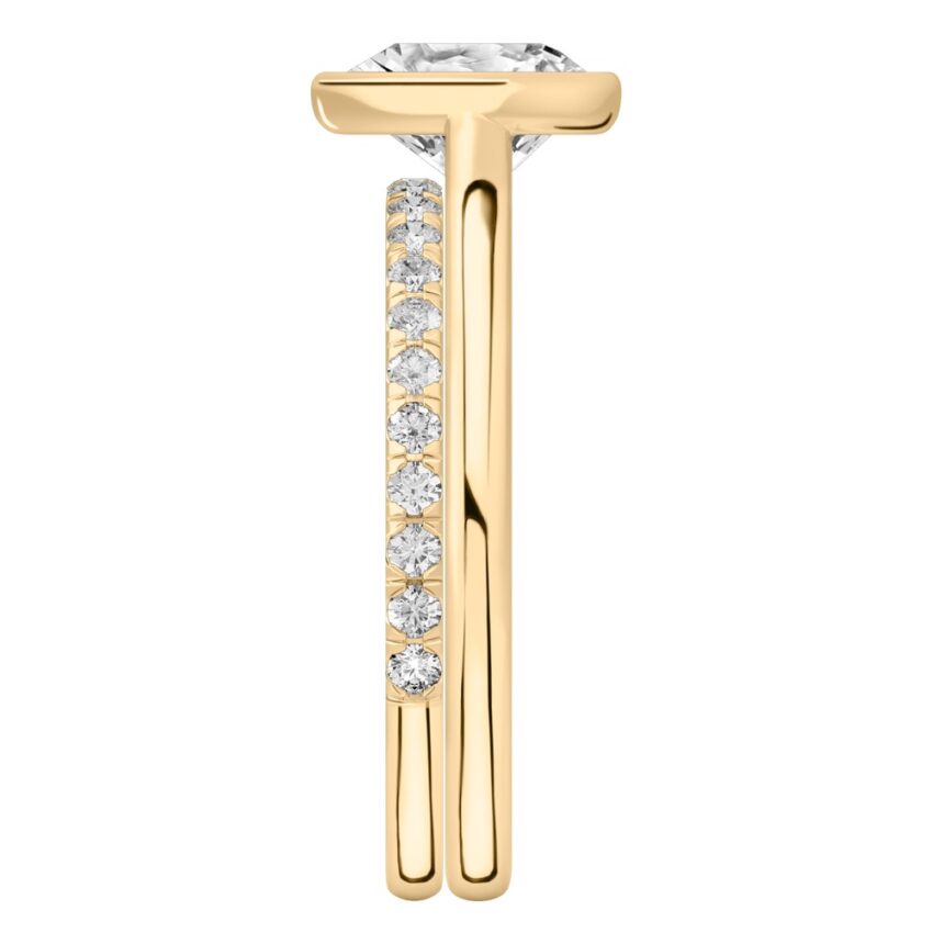Side view of heart shape diamond bezel engagement ring set yellow gold