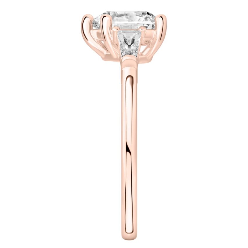 Side view of heart shape diamond tapered baguette engagement ring in rose gold