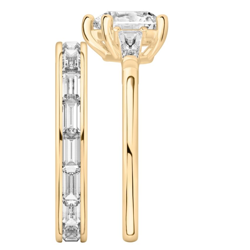 Side view of heart shape diamond tapered baguette engagement ring set yellow gold