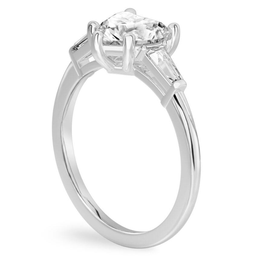 Angle view of heart shape diamond tapered baguette engagement ring in white gold