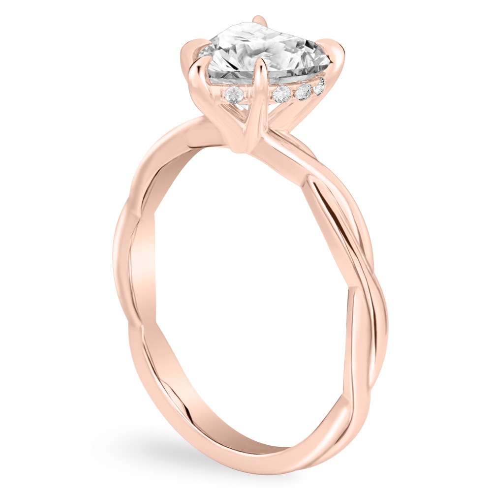Angle view of heart shape diamond twisted hidden halo engagement ring in rose gold