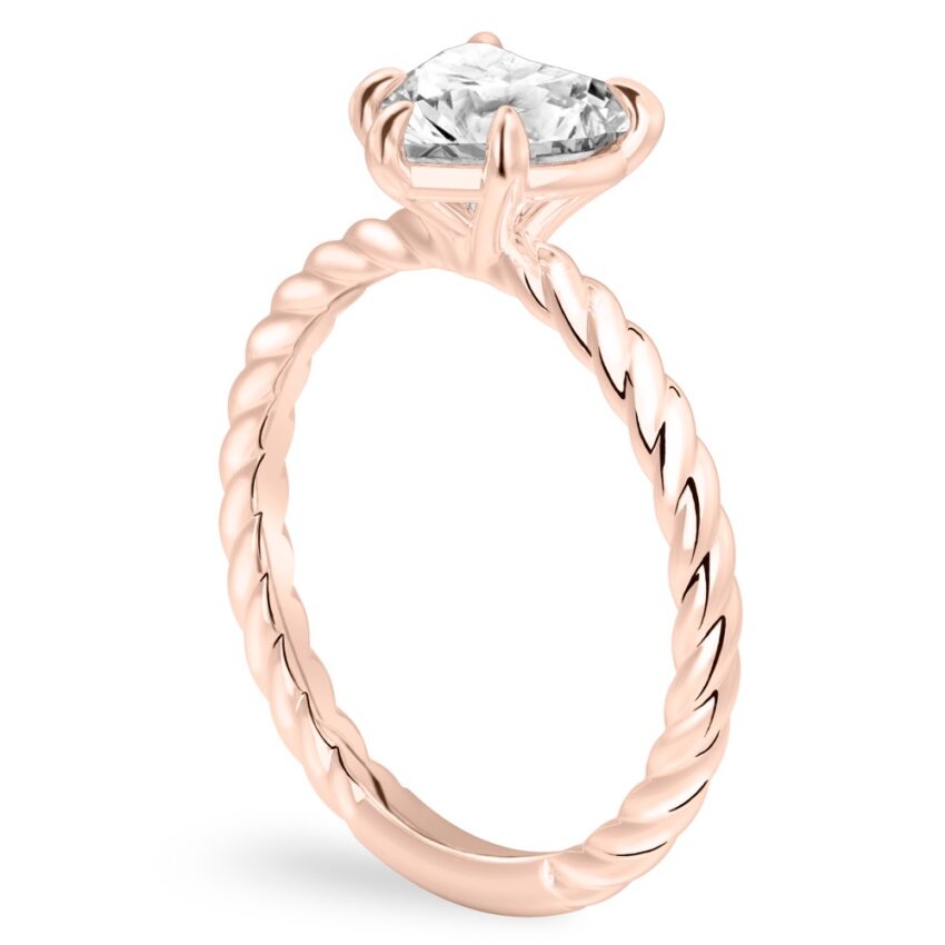 Angle view of heart shape diamond twisted rope engagement ring in rose gold