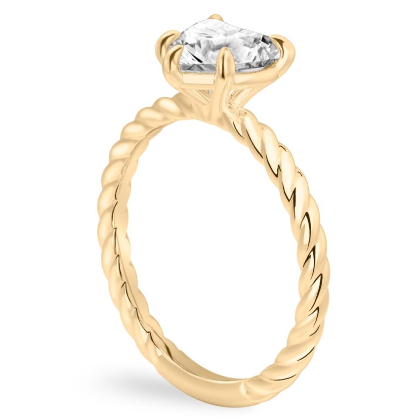 Angle view of heart shape diamond twisted rope engagement ring in yellow gold