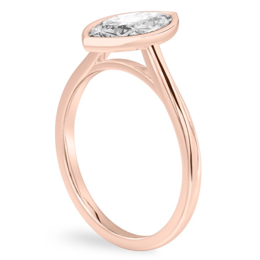 Angle view of marquise cut diamond bezel engagement ring in rose gold