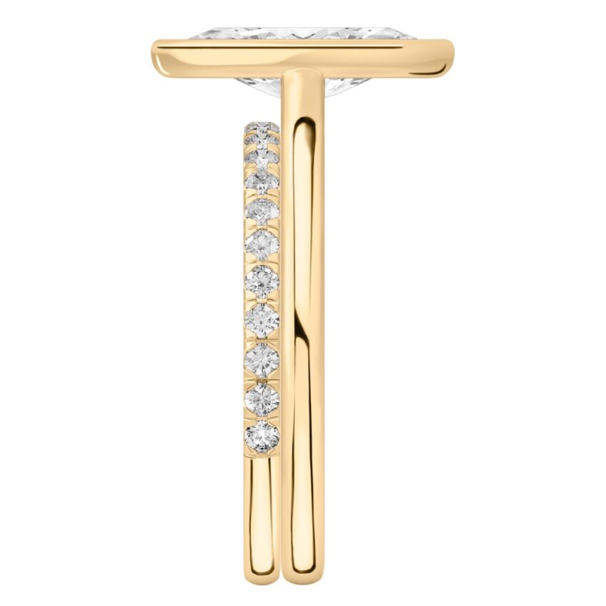 Side view of marquise cut diamond bezel engagement ring set yellow gold